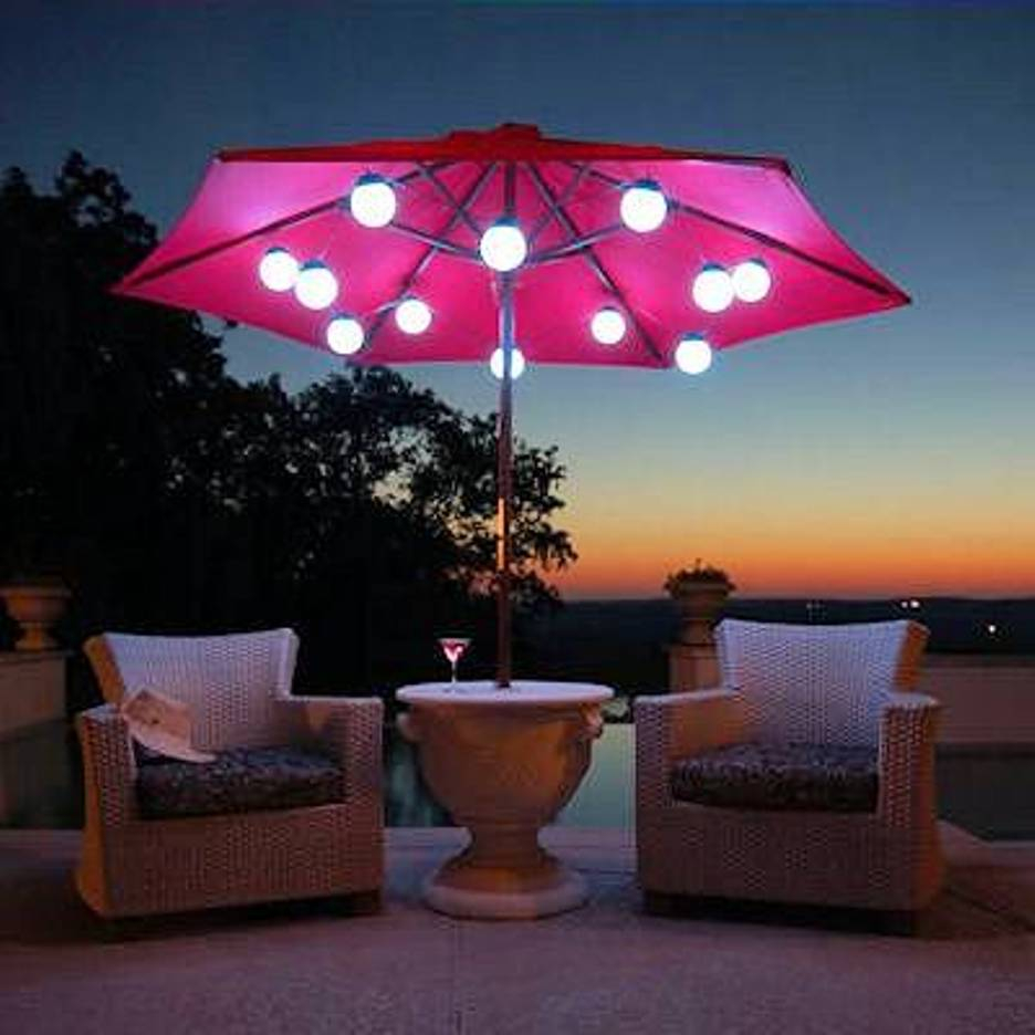 Patio Umbrella Marquee Lights White Wicker Chair Scene At Night pertaining to size 936 X 936